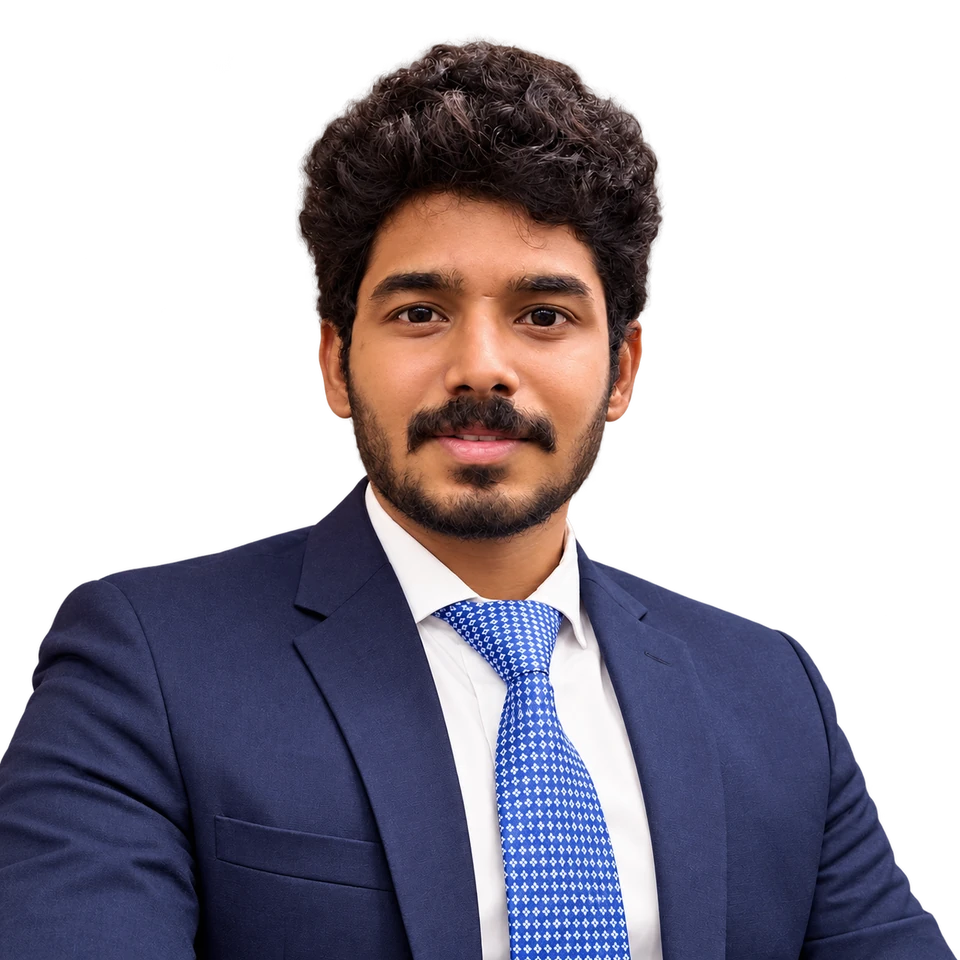 Teja P C in a navy suit and blue tie